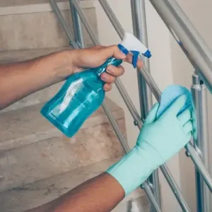 man-cleaning-staircase-handrail-gloves